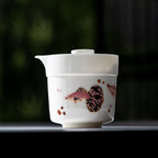 Close view of lidded white porcelain brewer nested over a pink-and-black guppy cup
