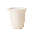 Front view of an ivory-white handleless pitcher with a flared rim and left-facing pouring lip on white