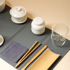 Close view of clear fairness pitcher, tea caddy, gaiwan, tea tools, tea towel and dark tea mat