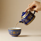 Qingding Gold Floral Teapot pouring into a matching cup