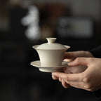 Wood Ash Four-Sunset Gaiwan held in both hands