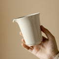 Wood Ash Horseshoe Fairness Pitcher held in hand