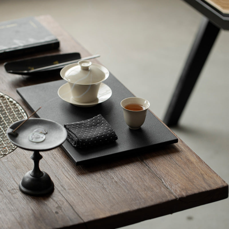 Wood Ash Magnolia Tasting Cup on a contemporary tea table