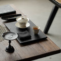 Wood Ash Magnolia Tasting Cup on a contemporary tea table