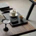 Wood Ash Magnolia Tasting Cup on a contemporary tea table