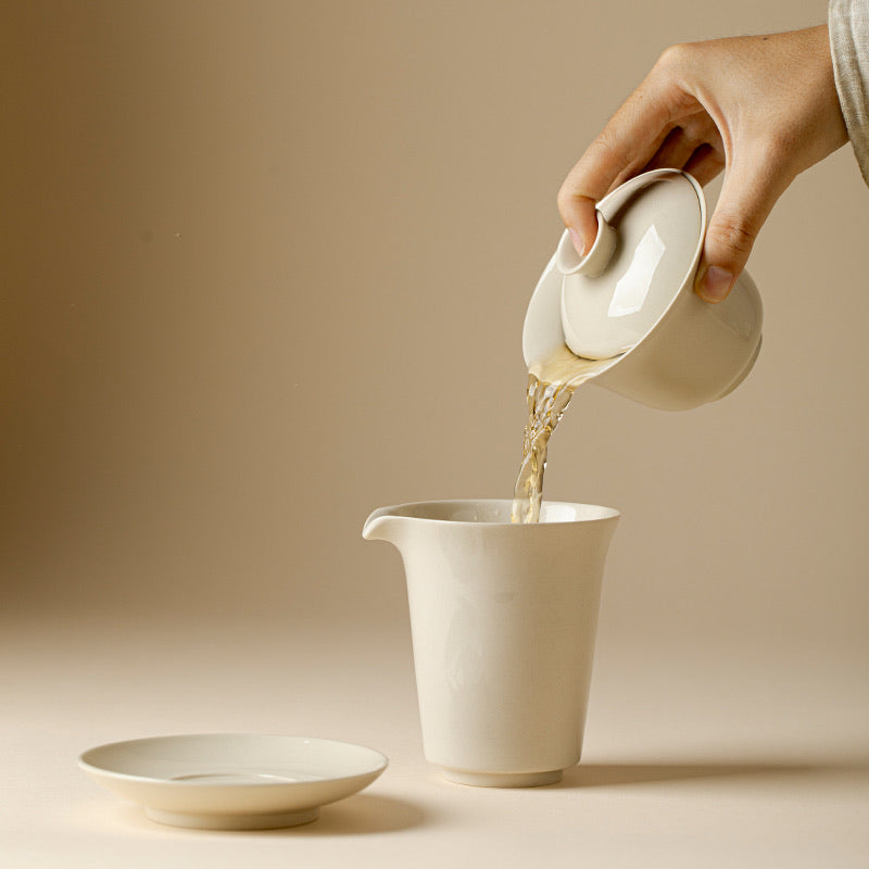 Wood Ash Nafu Gaiwan pouring tea into a fairness pitcher