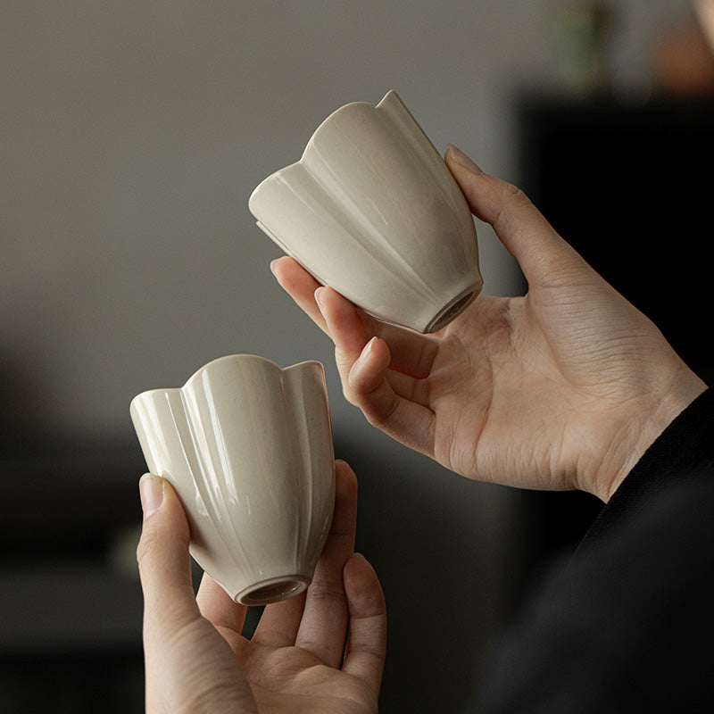 Wood Ash Plum Blossom Master Cup held in hand